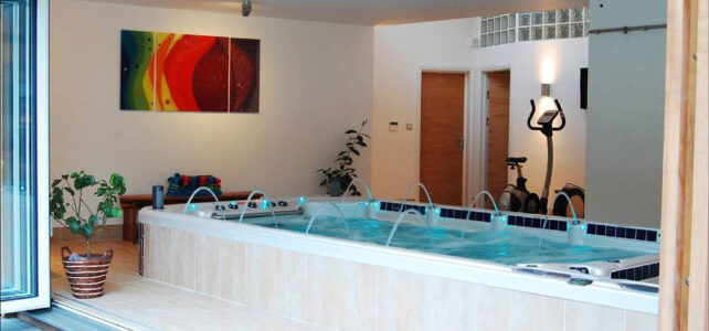 indoor hot tub with designer lighting and art