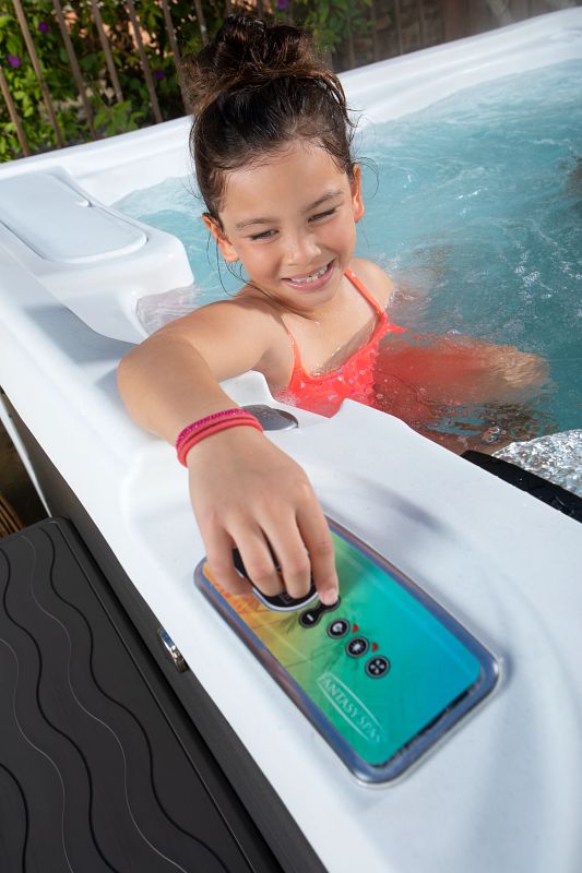 Young girl adjusting controls on Fantasy Spas hot tub