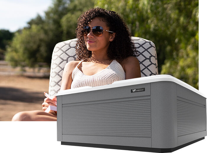 Woman sunbathing next to Calder Spas Vacanza series hot tub